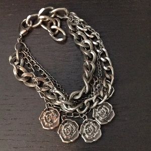Super cute silver rose multiple chain bracelet.